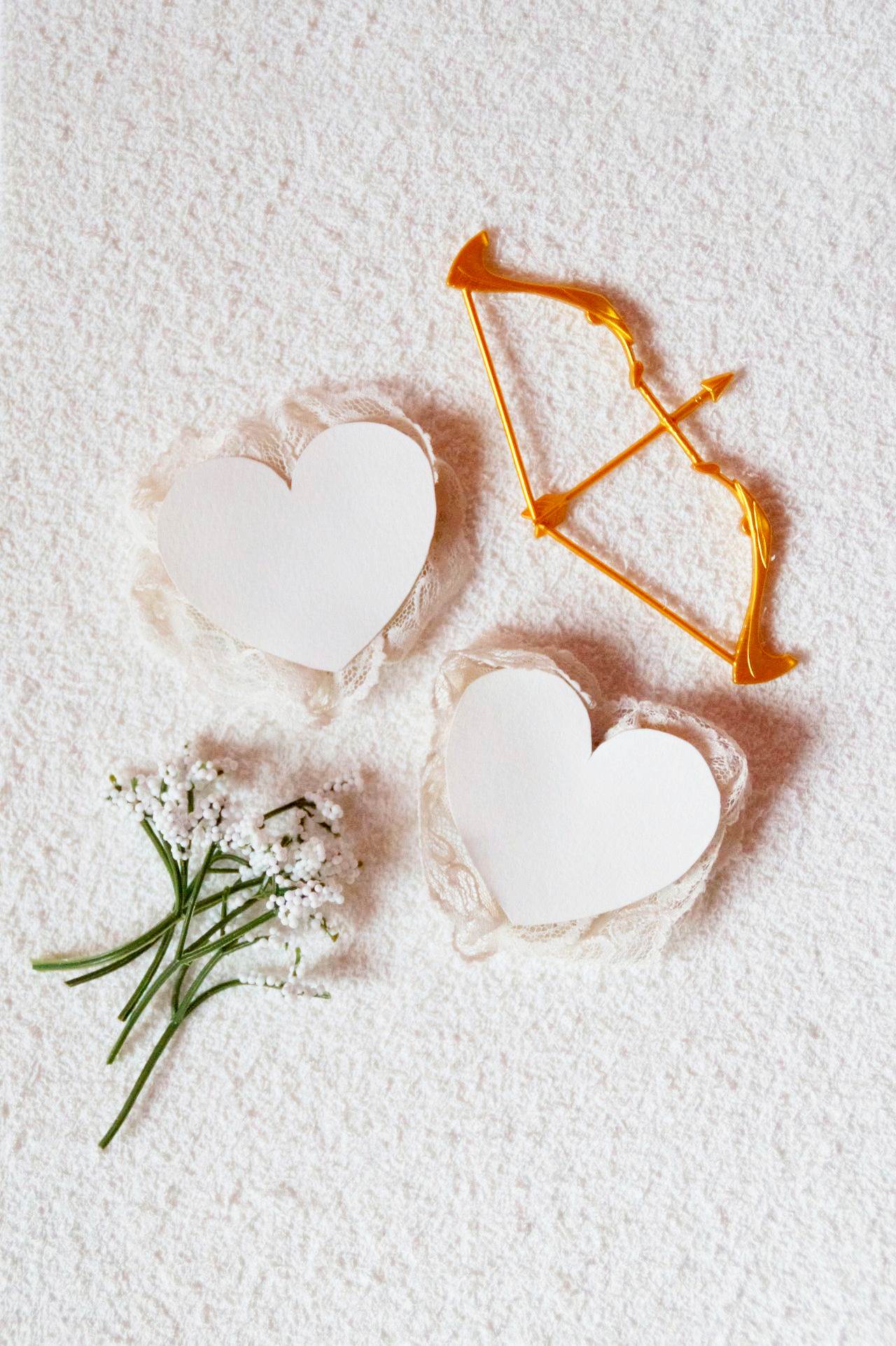 Photo by Mich Graphics: https://www.pexels.com/photo/valentines-day-flatlay-of-lacy-valentines-cards-white-flowers-and-a-golden-bow-and-arrow-15438132/